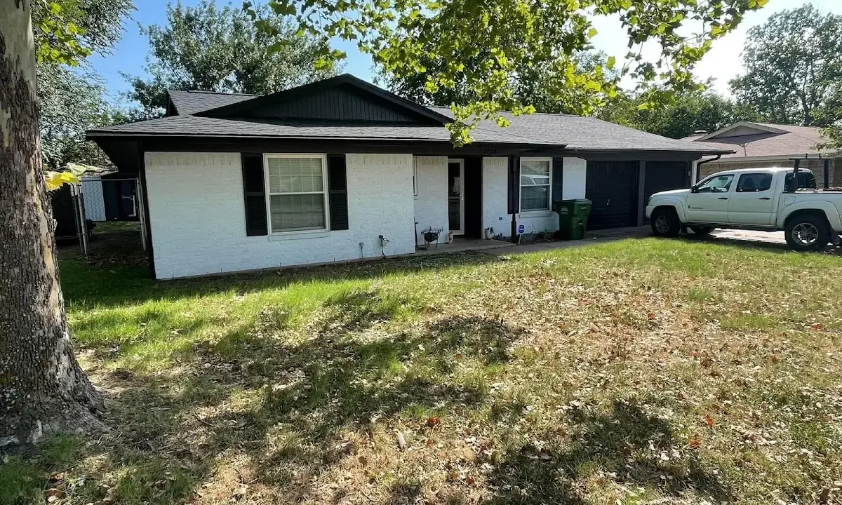 Professional roofing crew working on a residential roof in Bellefontaine